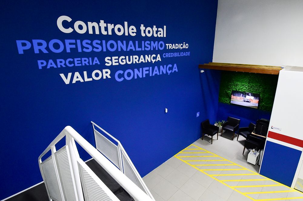 Interior moderno de franquia automotiva com valores da marca destacados em ambiente profissional e acolhedor